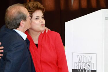 r_Brazil's presidential candidate for the ruling Workers' Party Dilma Rousseff (R) leaves a voting booth with Tarso Genro, Rio Grande do Sul's governor candidate of Workers' Party