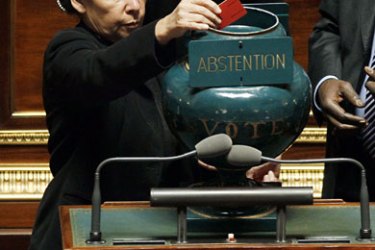 French senator Anne-Marie Payet, and Senate secretary, puts down ballots papers in a ballot box during the vote on the government's pension plan, on October 22, 2010, in Paris