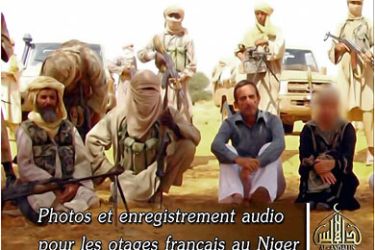 RESTRICTED TO EDITORIAL USE - MANDATORY CREDIT - AFP PHOTO / AL-ANDALUS / TV GRAB(FILES) This image grab taken on September 30, 2010 from a video released today shows hostages seized two weeks ago in Niger by Al-Qaeda in the Islamic Maghreb,