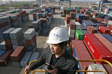 epa02110830 A worker directs a lift at a container port on the Yangtze River in Wuhan in central China's Hubei province 26 March 2010. China reported 10 April its first monthly trade deficit in nearly six years in March.