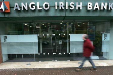 epa02099443 A man walks past a branch of the Anglo Irish Bank in Belfast, Northern Ireland, 31 March 2010