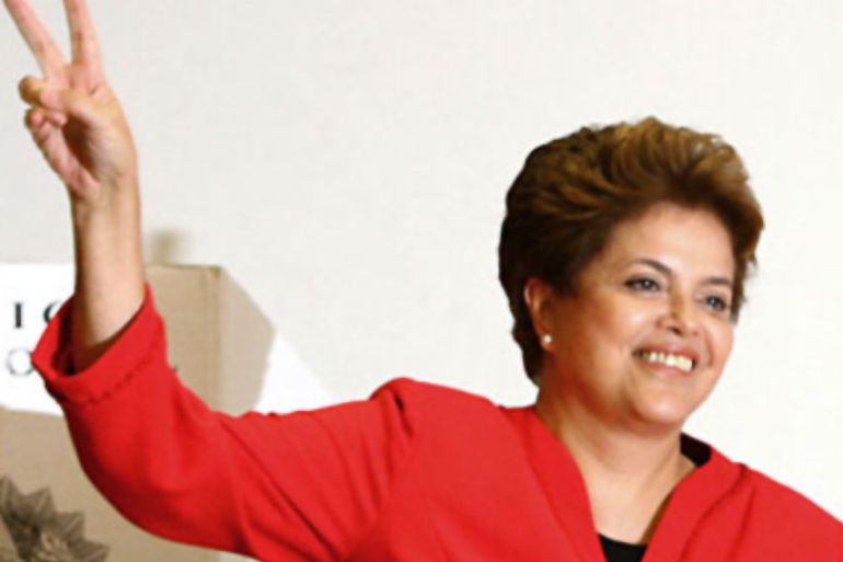 f_Dilma Rousseff, presidential candidate for the ruling Workers Party (PT) flashes the "v" sign after voting at a polling station in Porto Alegre, state of Rio Grande do Sul, Brazil, on October