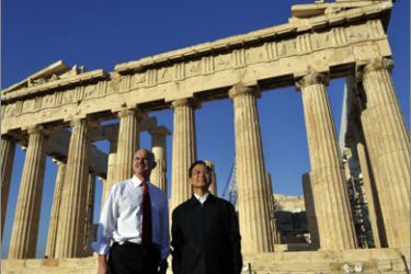 China's Premier Wen Jiabao and Greek Prime Minister George Papandreou (L) stand in front of the Parthenon Temple while visiting the ancient Acropolis in Athens on October 3, 2010. Wen Jiabao pledged yesterday badly needed investment and support to cash-strapped Greece, boosting Chinese influence in the country battling to emerge from an unprecedented