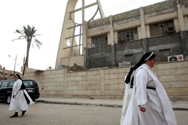 Iraqi nuns walk outside the Sayidat al-Nejat Catholic Cathedral, or Syrian Catholic Church, in central Baghdad on November 1, 2010, the day after seven security force members and 46 Christians including two priests were killed when US and Iraqi forces stormed the cathedral to free dozens of hostages in an attack claimed by Al-Qaeda gunmen. AFP PHOTO/AHMAD AL-RUBAYE