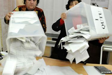 Members of Azerabaijan's election committee empty ballot boxes at a polling station in Baku on November 7, 2010. Azerbaijan voted in parliamentary elections set to cement President Ilham Aliyev's grip
