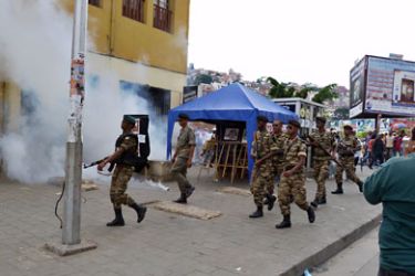 Police fire teargas to disperse a crowd of opposition supporters on November 20, 2010 in downtown Antananarivo.