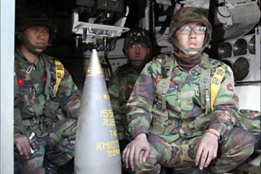 f_South Korean soldiers sitting in a K9 Thunder 155mm Self-Propelled Howitzers on Yeonpyeong island in the disputed waters of the Yellow Sea North Korea on November 25 blamed the South and the US for provoking its artillery bombardment of the island and warned it was ready to strike again, as a US carrier headed in for war games off the tense peninsula