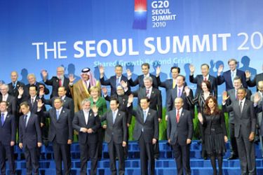 Attending members of the G20 group as well as invited guests wave as they pose together for the "family photo" following the plenary sessions at the G20 Summit in Seoul on November 12, 2010.