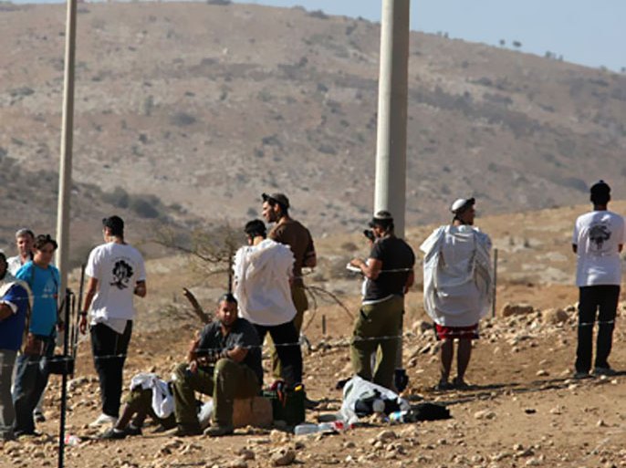 Jewish settlers trying to take control of Palestinian land pray in an area they fenced off in the West Bank village of Tubas, near the Jordan Valley, on November 9, 2010
