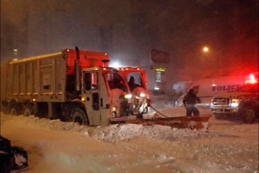 r_A driver of a snow plow stops to render assistance to the driver of a stuck ambulance during a snow storm in the Brooklyn borough of New York December 26, 2010