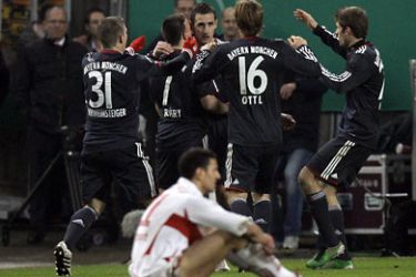 Bayern Munich's Miroslav Klose (C) celebrates his goal with his team mates as VfB Stuttgart's Khalid Boulahrouz sits on the pitch during their German Soccer Cup