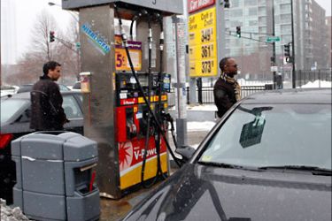 R_Motorists fill their tank at a Shell station in downtown Chicago December 24, 2010. The average price for a gallon of gasoline in the United States rose 7.59 cents per gallon even