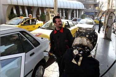 An Iranian man pumps gasoline into his car at a petrol station in Tehran on December 19, 2010. Iranian petrol prices surged four-fold as the government started scrapping