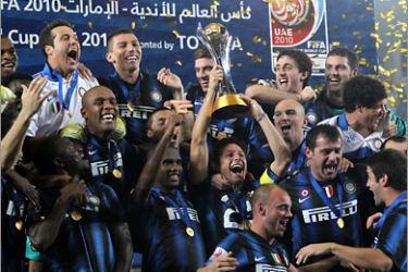 Inter Milan's players celebrate with the trophy after beating TP Mazembe in their 2010 FIFA Club World Cup final football match at Zayed Sports City in the Emirati capital Abu Dhabi on December 18, 2010.