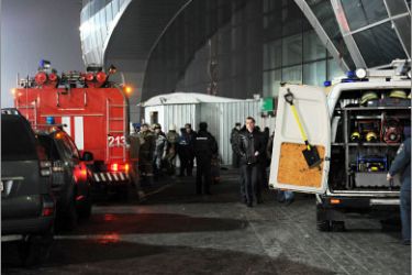 Firefighters and rescuers stand outside Moscow's Domodedovo international airport on January 24, 2011, shortly after an explosion. A suspected suicide bombing on January 24 killed at least 31 people and wounded over 100 at the airport in an attack described by investigators as an act of terror. Eyewitnesses, who spoke to Russian radio, described a scene of carnage after the blast ripped through the baggage claims section