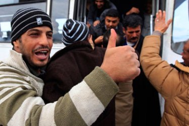 A Tunisian prisoner freed from the Borj Lamary jail near Tunis gives the thumbs up, January 20, 2011. Several prisoners were freed after Tunisia's new coalition government ordered the release of all political prisoners.