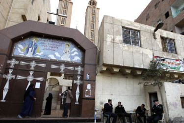 Egyptian police officers guard the al-Azraa Christian Coptic church in the Shubra neighborhood Cairo on January 5, 2011. Egyptian security forces are on alert as Coptic Christmas start January 06. AFP PHOTO