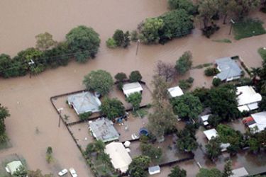 epa02508049 An aerial view of flood water surging in the Old town of Theodore, Australia, 26 December 2010. Inland communities are braced for flooding as heavy rain continues to fall across north, central and southeast