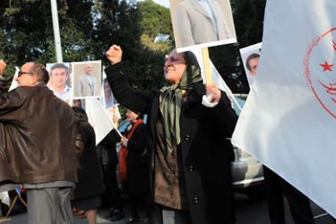 Demonstrators hold photos of two activists from the Iranian exiled opposition group, People's Mujahedeen of Iran (PMOI) executed in Iran during a protest in front of Iran's embassy on January 27, 2011 in Rome