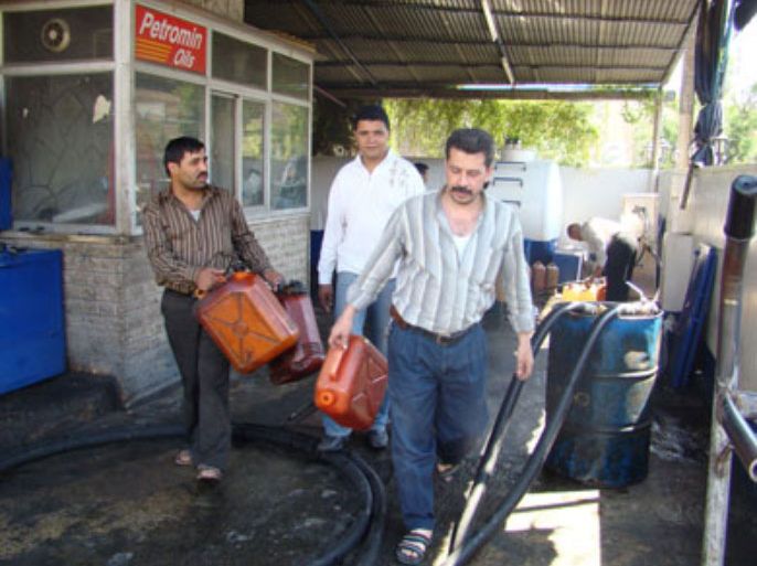 سوريون يملؤون غالونات بالمازوت من احدى محطات الوقود للتدفئة ـ الجزيرة نت
