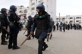 epa02463738 Algerian riot police are seen during clashes in El Anasser suburb of Algiers, Algeria, 23 November 2010. Protesters clashes with riot police by throwing stones and other projectiles in protest against the demolition of their shanty town. EPA