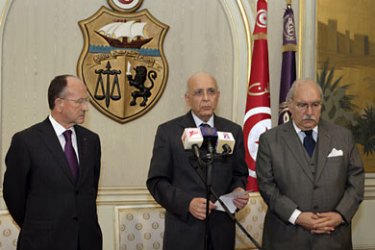 A hand out picture raleased on January 14, 2011 by the Tunisian press agency TAP shows Tunisian Prime Minister Mohammed Ghannouchi (C) addresses the nation on state television, flanked by Abdallah Kallel (L), president of the Chamber of Advisers of Tunisia and the President of the Tunisian Parliament Fouad Mbazaa, on that he had taken over as interim president after Zine El Abidine Ben Ali had left the country.