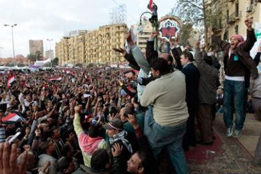 Anti-government protesters celebrate as a senior army soldier addresses the crowd inside Tahrir Square in Cairo February 10, 2011. Egyptian President Hosni Mubarak is on the verge of capitulating to protester demands to give up power but may still seek to hold on in a nominal capacity by giving presidential powers to his deputy or a joint leadership involving an army council.