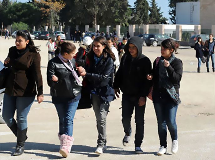Tunisian students walk in front of a Carthage school on February 4, 2011 in Tunis. European Union lawmakers meet with Tunisia's interim government today in post-crisis talks following the regional bloc's pledge to help the country's democratic transition.
