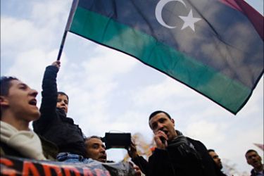 r_Protestors wave flags during a demonstration against Libyan leader Muammar Gaddafi and the Italian government outside the Italian embassy in Bern February 22, 2011