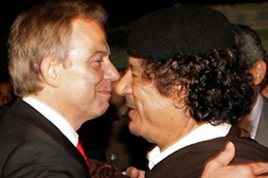 Prime Minister Tony Blair (L) embraces Colonel Moammar Gadhafi after a meeting on May 29, 2007