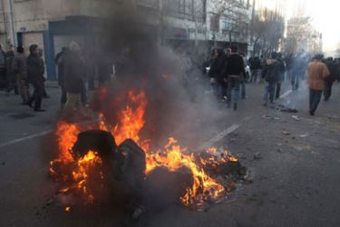 A dumpster burns on a street during clashes between anti-government protestors and police near Azadi Square in Tehran February 14, 2011. Dozens of Iranian opposition supporters were arrested on Monday while taking part in a banned rally in Tehran to support popular uprisings in Egypt and Tunisia, an Iranian opposition website said.