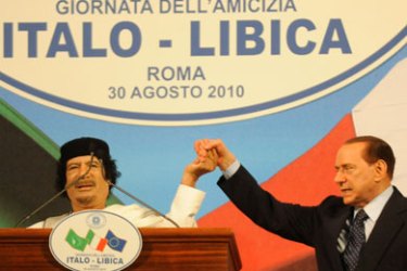 ROME - AUGUST 30: Libyan leader Muammar Gaddafi (L) shakes hands with Italian Prime Minister Silvio Berlusconi (R) during a ceremony for the Italia - Libya friendship day at Salvo D'Acquisto barraks, on August 30, 2010 in Rome, Italy.