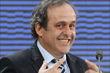 f_French UEFA president Michel Platini smiles during a press conference on March 22, 2011 in Paris as part of the 35 edition of the UEFA convention. Platini was re-elected