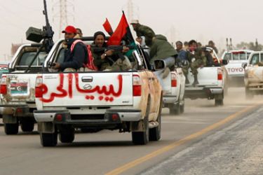 Rebel fighters flee from Ajdabiyah, outside Ajdabiyah on the road to Benghazi, March 15, 2011. Libyan leader Muammar