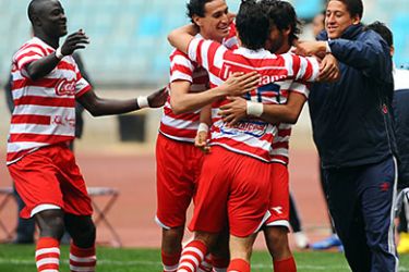Tunisia Club Africain players hug their teammate Youssef Mouihbi (C) after he scored against Egyptian Zamalek during their African Champions League football match on March 20, 2011 in Rades Olympic