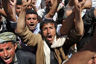 Yemeni anti-government protesters shout slogans during a demonstration demanding the ouster of Yemeni President Ali Abdullah