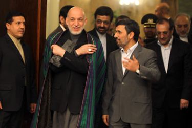 Iranian President Mahmoud Ahmadinejad (R) greets his Afghan counterpart Hamid Karzai upon his arrival