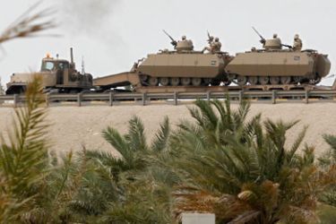 Armoured personnel carriers are transported on the flyover near the Bahrain Saudi bridge in Manama March 15, 2011.