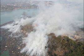 r_Smoke rises after a magnitude 8.9 earthquake and tsunami hit Kesennuma City, Miyagi Prefecture in northern Japan March 13, 2011