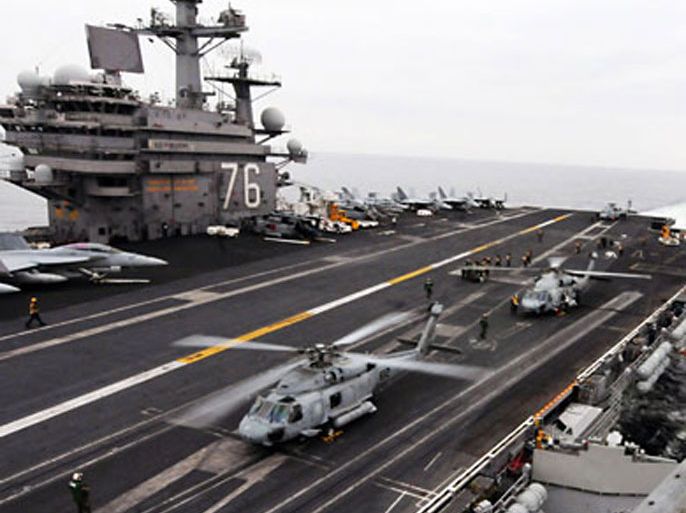 HH-60H Sea Hawk helicopters from the Black Knights of Helicopter Anti-Submarine Squadron (HS) 4 prepare to lift off after resupplying on the flight deck of the aircraft carrier USS Ronald Reagan positioned off the coast of Japan, in this U.S. Navy handout photo dated March 15, 2011