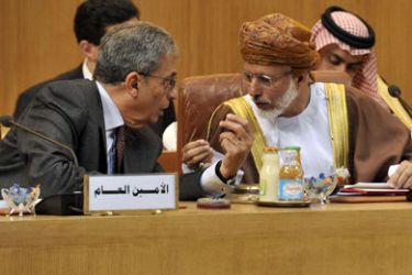 Arab League Secretary General Amr Mussa (L) speaks with Omani Foreign Minister Youssef Ben Alaoui before the opening of a extraordinary Arab League meeting to discuss a response to the crisis in Libya, including the possible imposition of a no-fly zone, on March 12, 2011 in Cairo.
