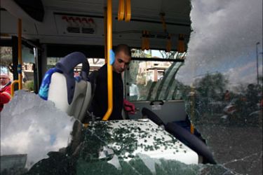 r_An Israeli police officer surveys the inside of a damaged bus at the scene of an explosion in Jerusalem March 23, 2011. A bomb exploded near a bus stop in a Jewish district
