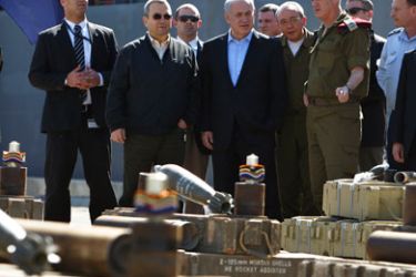 Israel's Prime Minister Benjamin Netanyahu (4th L), Defence Minister Ehud Barak (2nd L) and Chief of Staff Lieutenant-General Benny Gantz (5th R) stand next to mortar shells on display at the port of Ashdod March 16, 2011 after they were seized by Israeli naval commandos on Tuesday.