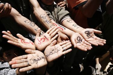 Anti-regime protesters show slogans marked on their hands in Arabic and English during a demonstration calling for the ouster of Yemeni President Ali Abdullah Saleh in central Sanaa on April 4, 2011, as security forces shot dead 17 fellow demonstrators and wounded scores more on the second day of lethal clashes in Taiz, south of the capital, medics said.