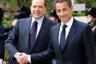 Italian Prime Minister Silvio Berlusconi (L) and French President Nicolas Sarkozy shake hands as they arrive for a meeting at Villa Madama in Rome April 26, 2011. Sarkozy arrives in Rome on Tuesday looking to end a row over North African immigration and ease tensions over a bid by France's Lactalis to acquire Italy's largest listed food group Parmalat.