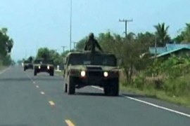 r_Thai military trucks with soldiers are driven to the Thai-Cambodia border for reinforcement in this still image taken from video April 22, 2011.