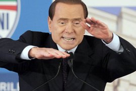 r_Italian Prime Minister Silvio Berlusconi gestures during a political party meeting in downtown Milan April 17, 2011. REUTERS/Alessandro Garofalo (ITALY