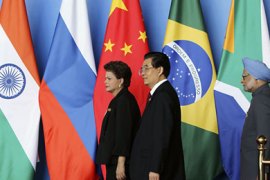 r_Brazil's President Dilma Rousseff (L), China's President Hu Jintao (C) and India's Prime Minister Manmohan Singh arrive at a joint news conference at the BRICS Leaders Meeting