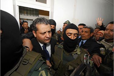 The son of former president Ben Ali, Imed Trabelsi (C) arrives on April 20, 2011 at the palace of justice in Tunis