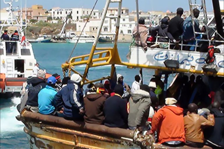 Refugees who flew Libya arrive on a boat on the Italian island of Lampedusa on April 19, 2011. 760 people were aboard a 20-meter boat arriving from Libya. AFP PHOTO